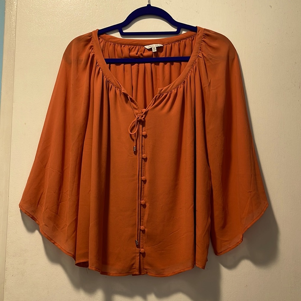 Beautiful, flutter sleeve blouse in a light rust color